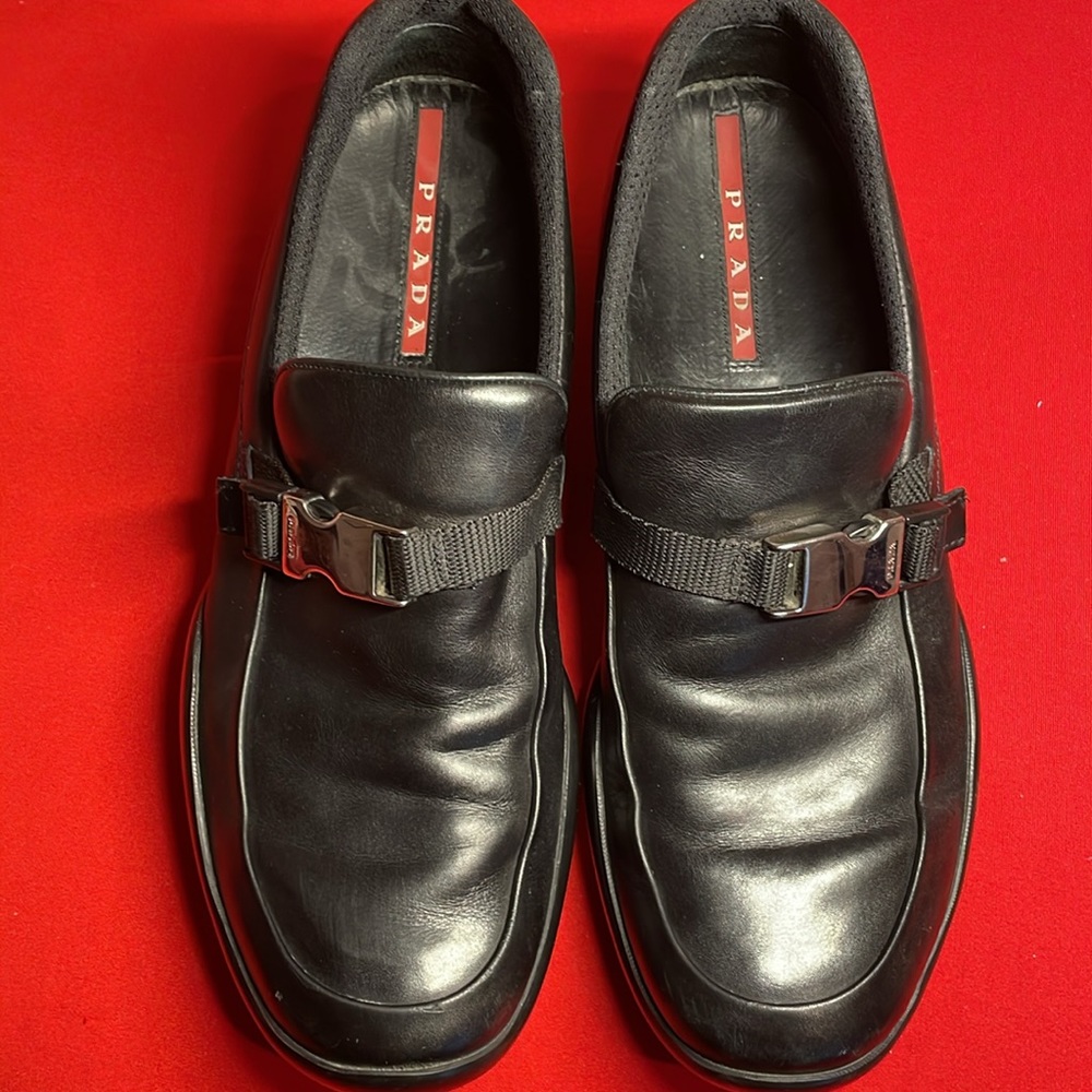 PRADA MENS’ BLACK LEATHER SLIP ON SHOES WITH BUCKLE (6.5)